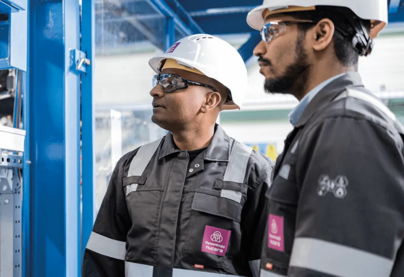 employees in front of alkaline water electrolyzer